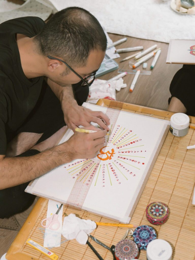 Bên Trong 1 Lớp Học Chuông Tại Madahuma Healing 11 Người cầm bút vẽ tranh trên giấy trắng.