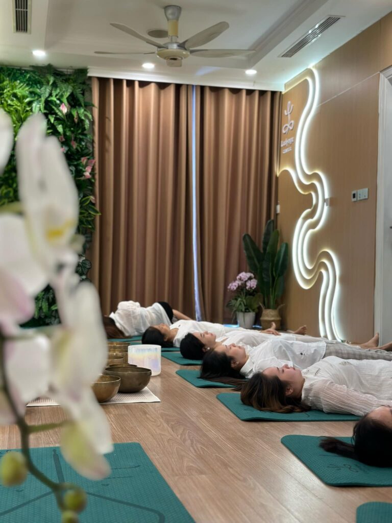 Nhóm người thư giãn tại spa với nến và nhạc.