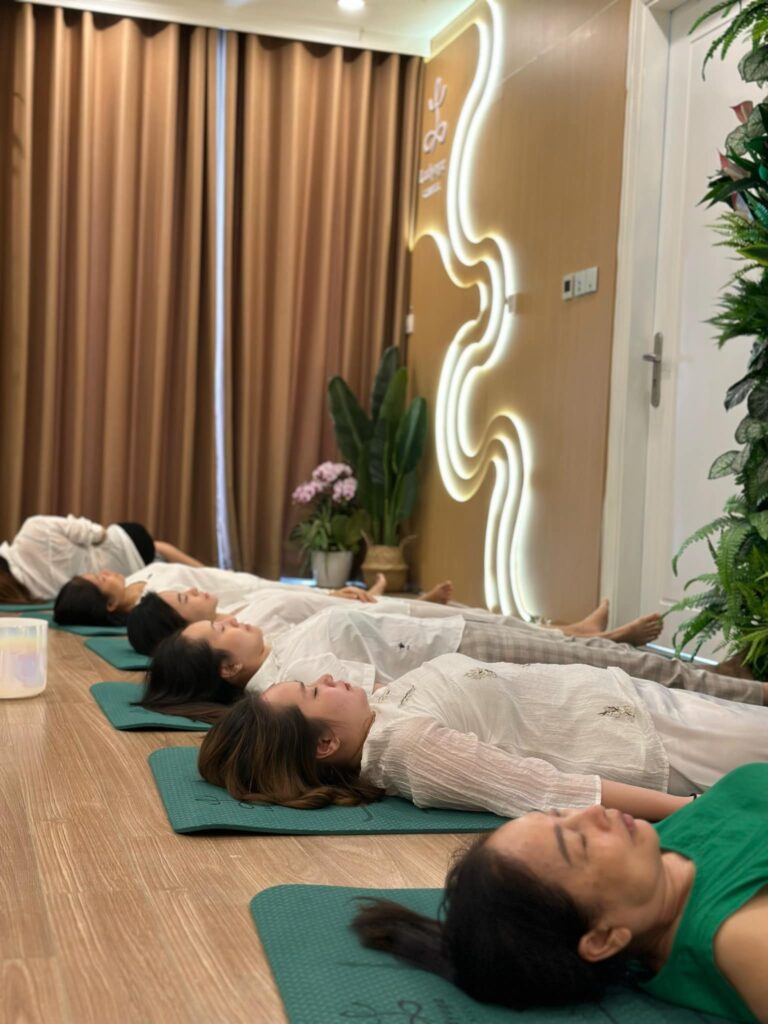Người nằm trên thảm tập yoga trong phòng thư giãn.